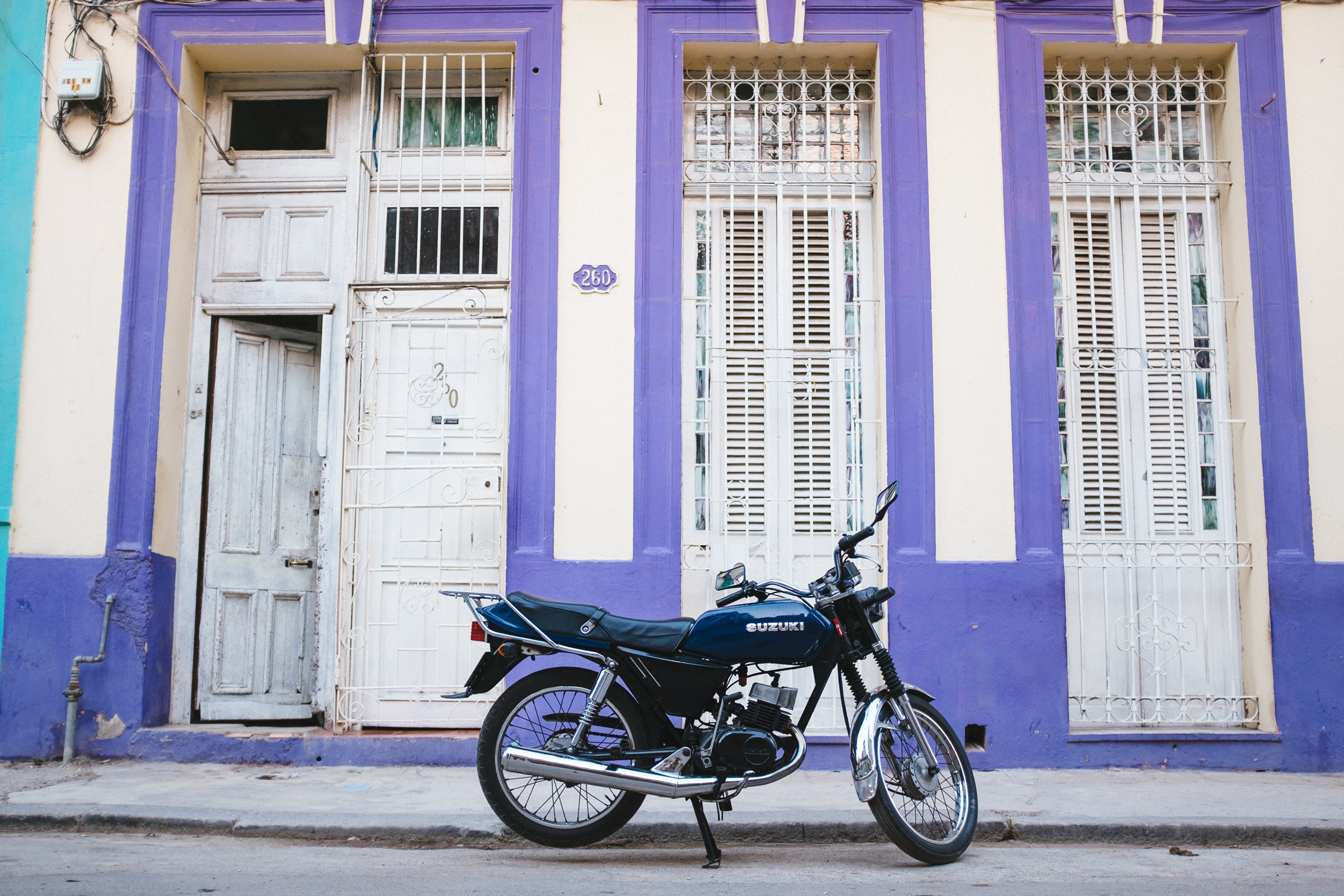 A 2-stroke Suzuki in Havana. Photo Credit: Adam Nagel